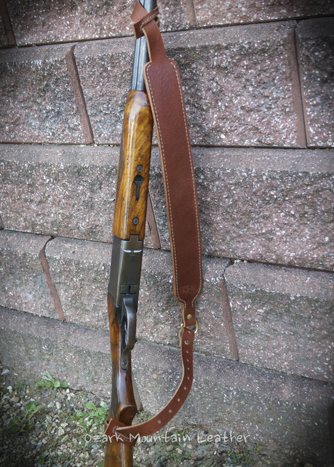 Custom leather shot gun rifle sling in brown. Can be personalized with name or initials and also a custom stamp option. Custom leather shot gun rifle sling in brown. Can be personalized with name or initials and also a custom stamp option.