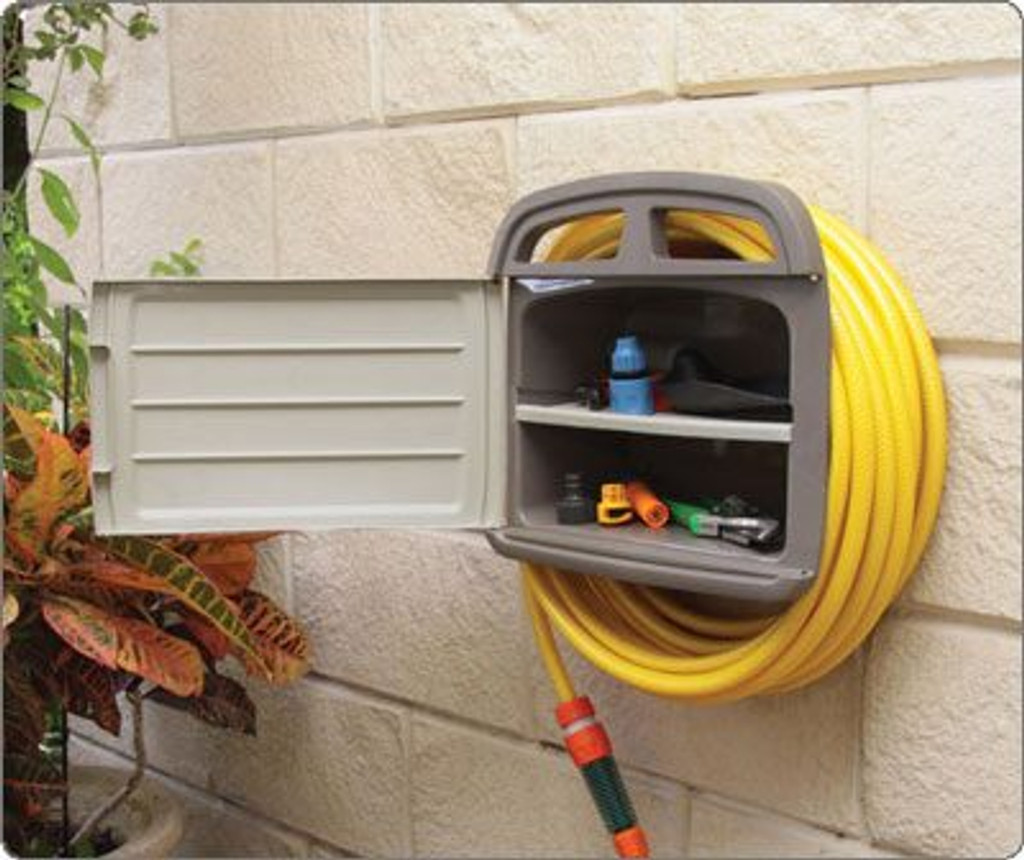 Hose hanger outside in the garden with tools
