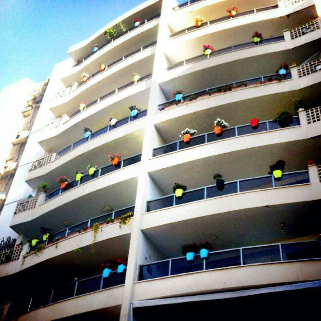 Greenbo railing planters on buildings.