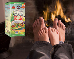 Get Vitamin Code Kids Wholefood Multivitamins for Children Two pairs of feet, one larger like a father's, and one smaller like a child's, sitting right on top of the first pair, in front of a fireplace fire, with a box of Garden of Life Vitamin Code Kids Whole Food Multivitamins for Children.