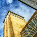Manufacturers Looking up at the sky framed by factory buildings