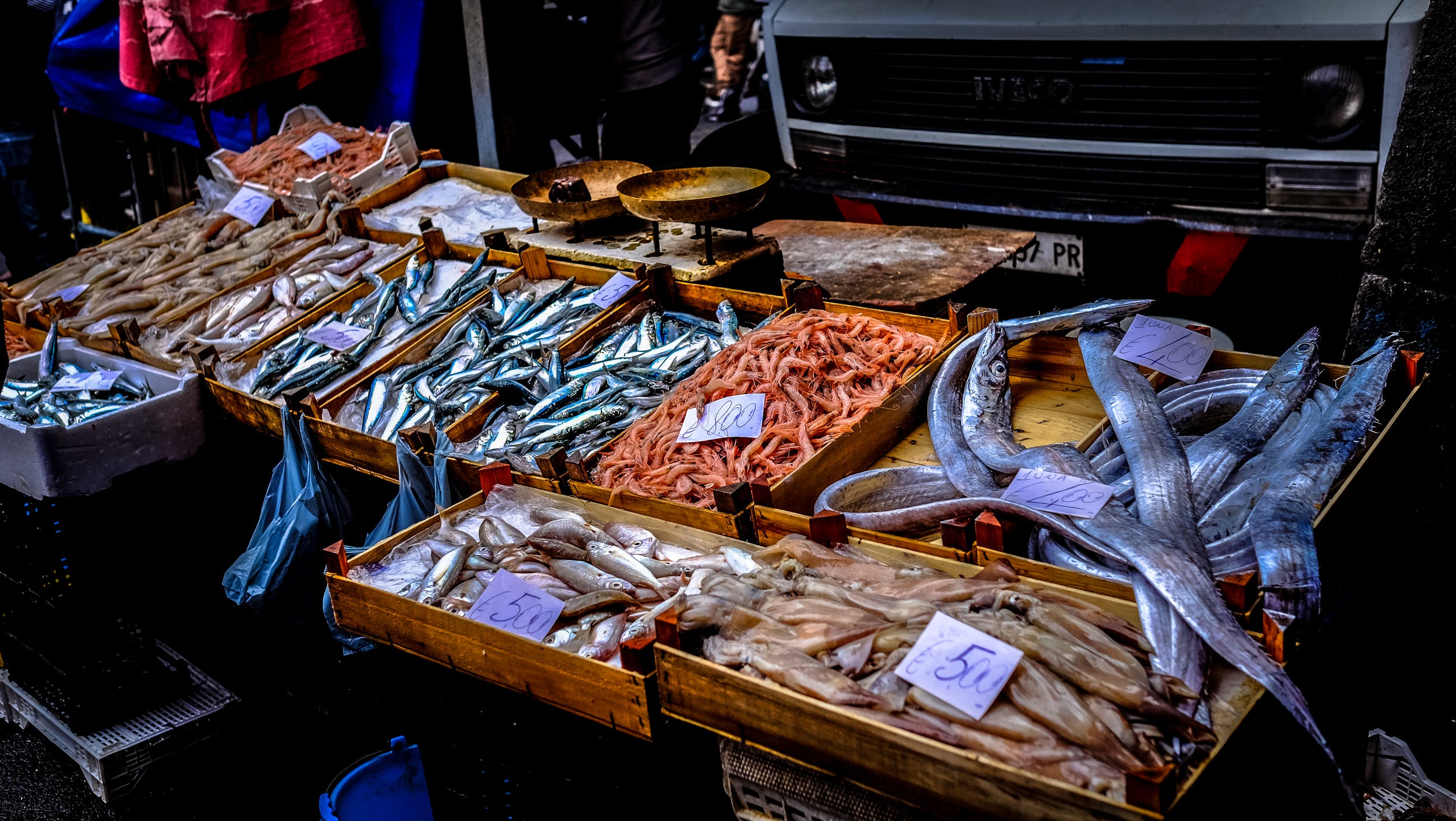 A market stall offering a variety of fresh raw seafood