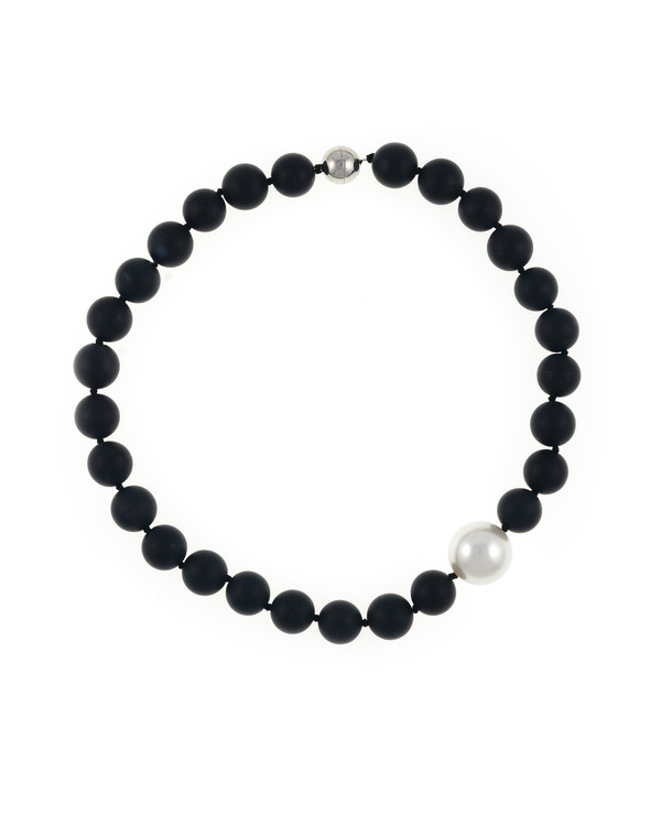 London Eye Pearl and Onyx Necklace: Single strand black untumbled onyx beads 14mm, featuring an offset single shell pearl 20mm, on individually hand-knotted black silk, with rare earth magnetic mixed metal clasp